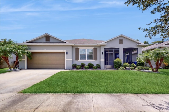 single story home with a garage and a front lawn