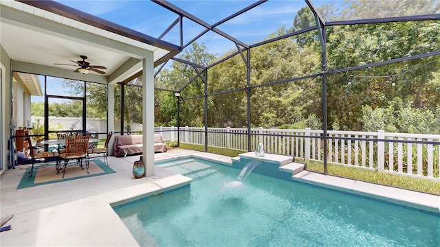 view of swimming pool with pool water feature, ceiling fan, a lanai, and a patio