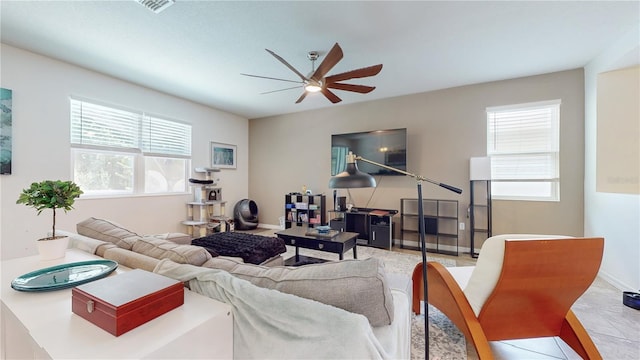 living room featuring a wealth of natural light and ceiling fan