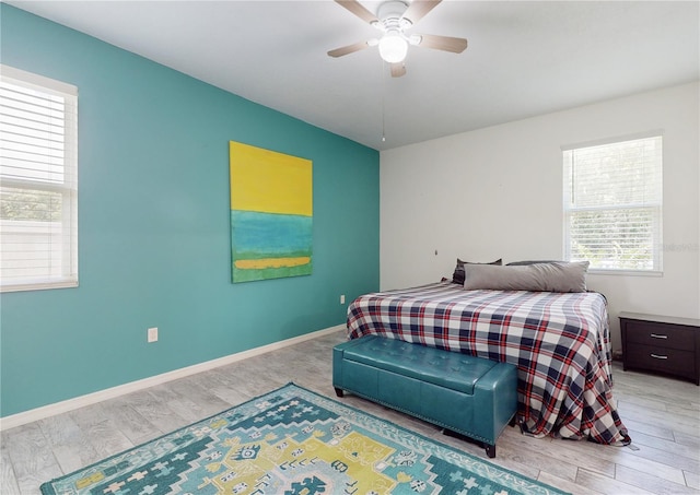 bedroom with ceiling fan and light hardwood / wood-style floors