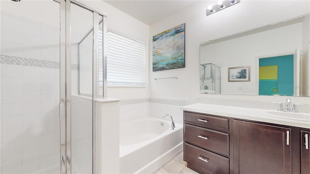 bathroom featuring tile patterned flooring, shower with separate bathtub, and vanity