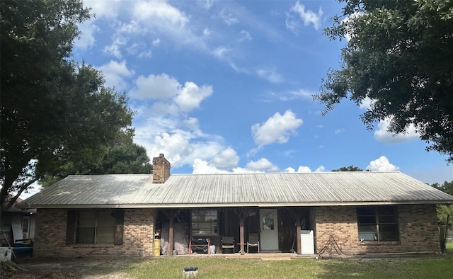 rear view of property with a lawn