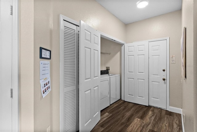 hallway with dark hardwood / wood-style flooring and washing machine and clothes dryer