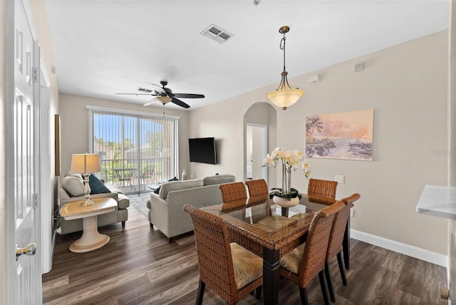 dining space featuring dark wood-type flooring and ceiling fan