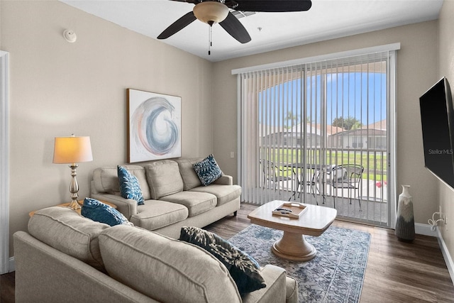 living room featuring dark hardwood / wood-style floors and ceiling fan