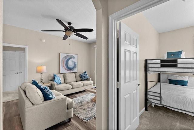 living room with hardwood / wood-style flooring and ceiling fan