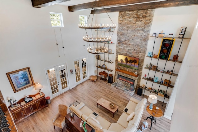 living room with hardwood / wood-style floors, beam ceiling, and a high ceiling