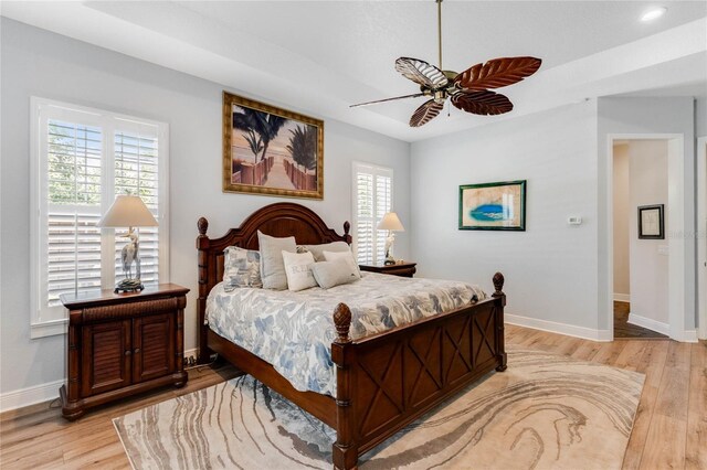 bedroom with ceiling fan and light hardwood / wood-style flooring