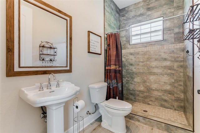 bathroom featuring toilet, hardwood / wood-style floors, and a shower with shower curtain