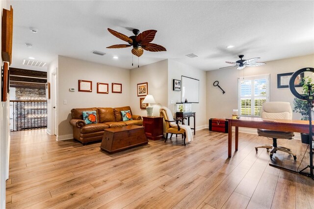 office area with ceiling fan and light hardwood / wood-style flooring