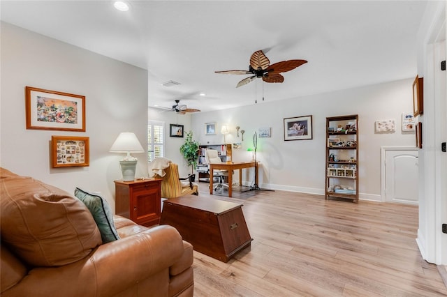 living room with light hardwood / wood-style flooring and ceiling fan