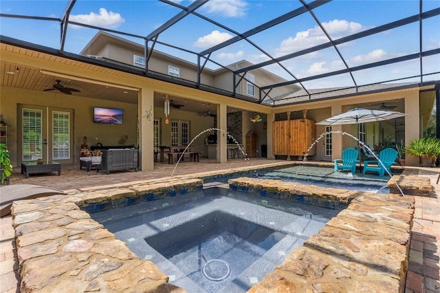 view of swimming pool with ceiling fan, a lanai, an in ground hot tub, and a patio