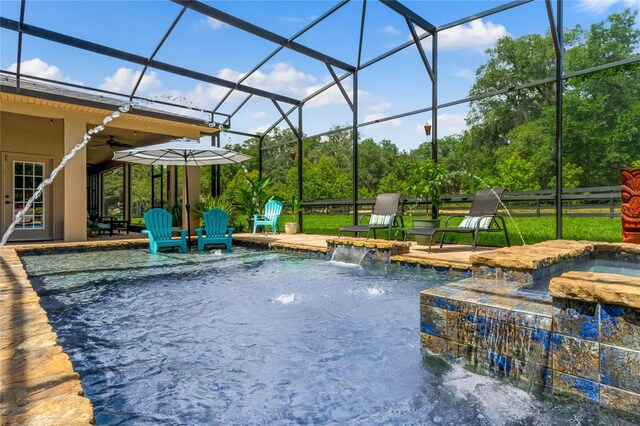 view of swimming pool featuring an in ground hot tub, a lanai, pool water feature, ceiling fan, and a patio area