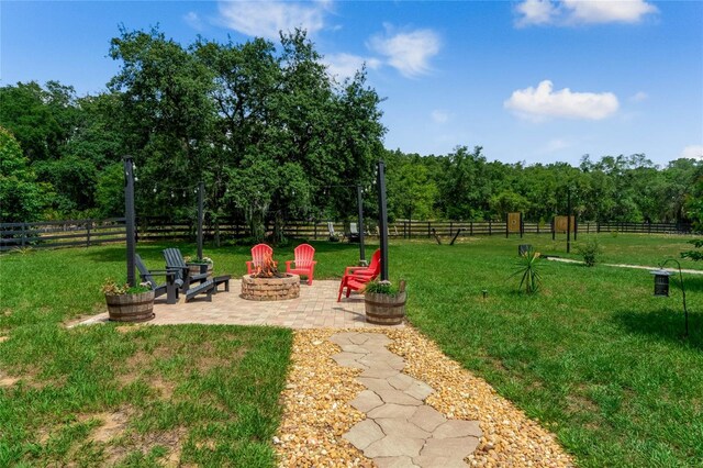 view of yard featuring a patio and a fire pit