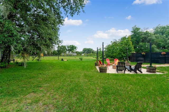 view of yard featuring a patio and a fire pit