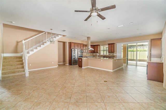 kitchen with light tile patterned flooring, tasteful backsplash, island exhaust hood, ceiling fan, and stainless steel refrigerator with ice dispenser