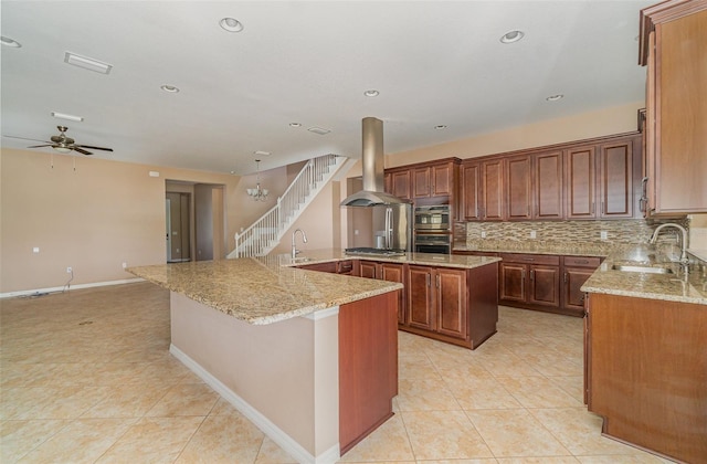 kitchen featuring sink, a kitchen island, light stone countertops, island exhaust hood, and decorative backsplash