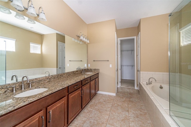 bathroom featuring vanity, plus walk in shower, and tile patterned flooring