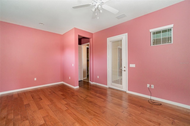 empty room with ceiling fan and wood-type flooring