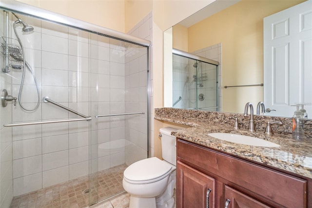 bathroom with vanity, toilet, and walk in shower