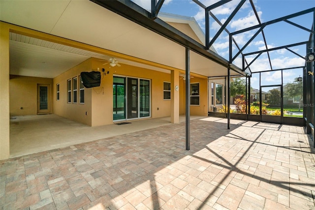 exterior space featuring beamed ceiling, ceiling fan, and plenty of natural light