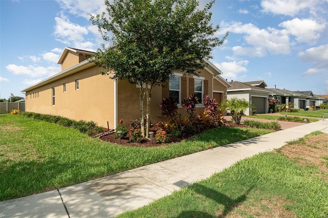 view of home's exterior featuring a garage and a yard