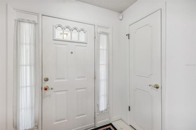 entrance foyer featuring a textured ceiling