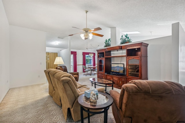 living room with a textured ceiling, ceiling fan, light colored carpet, and lofted ceiling