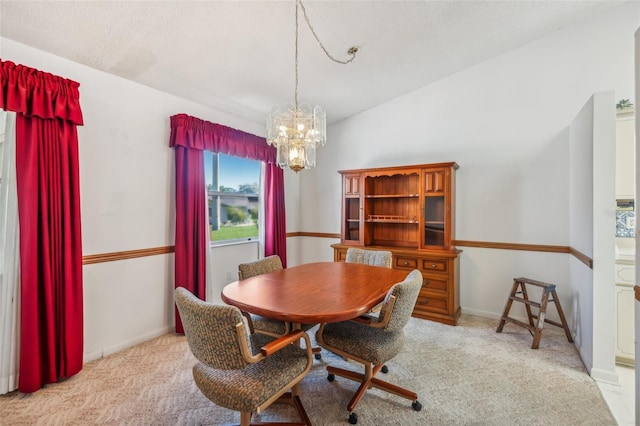 dining room featuring a chandelier and light colored carpet