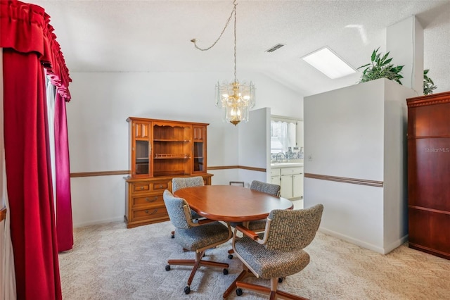 carpeted dining room featuring sink, vaulted ceiling, and a notable chandelier