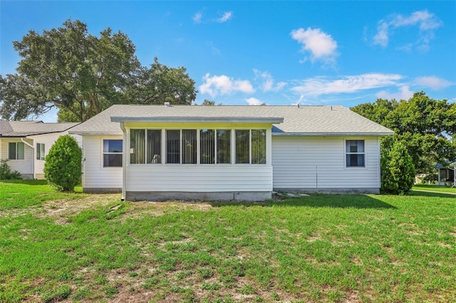 rear view of property with a lawn