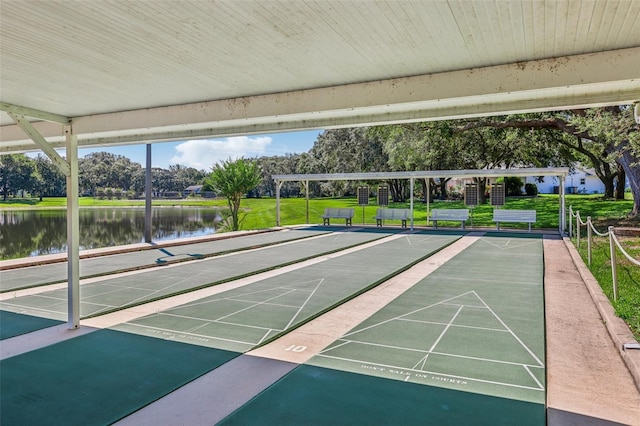 surrounding community featuring a lawn and a water view