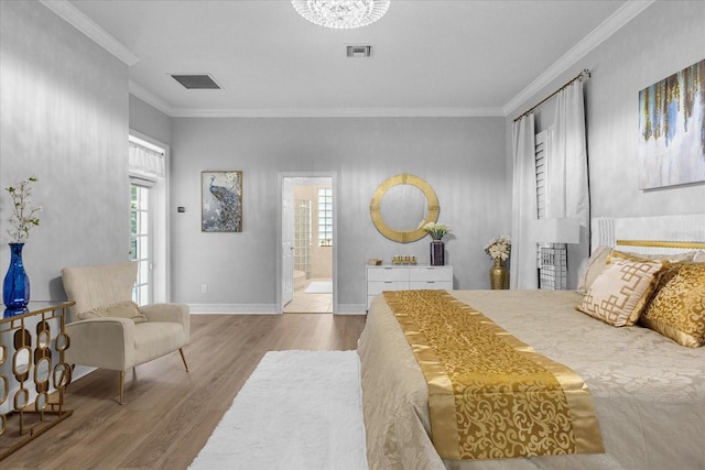 bedroom featuring ensuite bathroom, wood-type flooring, and ornamental molding