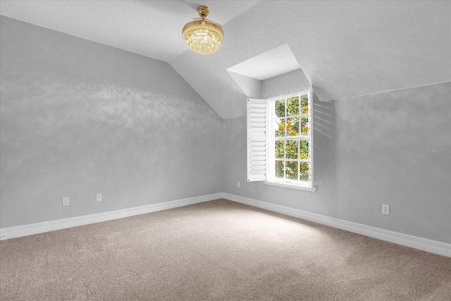 bonus room featuring a textured ceiling, carpet floors, and vaulted ceiling