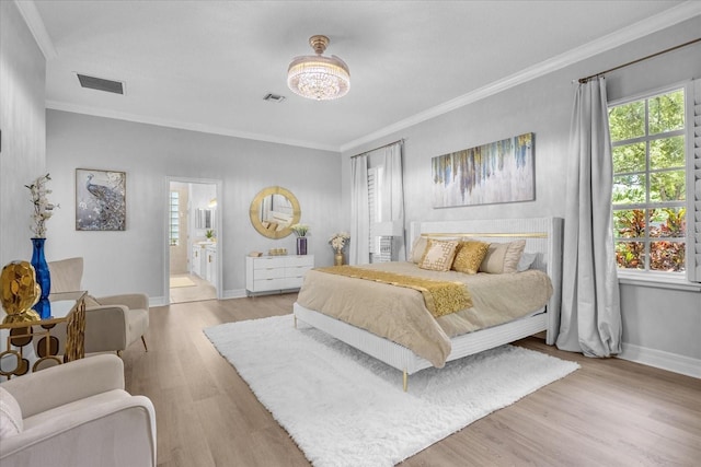 bedroom featuring light wood-type flooring, ensuite bath, and ornamental molding