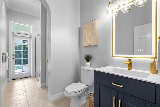 bathroom with tile patterned flooring, vanity, toilet, and ornamental molding