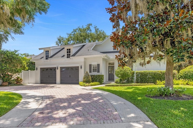 view of front of house featuring a garage and a front lawn