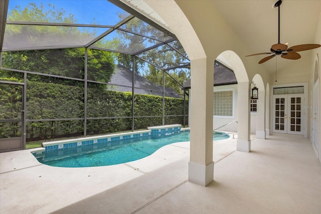 view of swimming pool with a lanai, a patio area, ceiling fan, and french doors