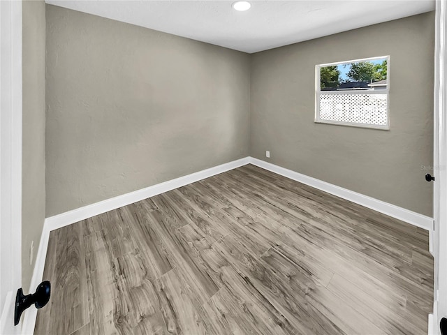 unfurnished room featuring hardwood / wood-style flooring