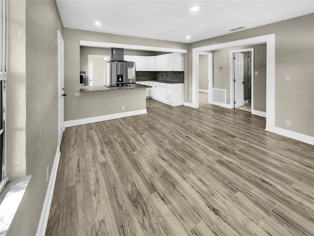 unfurnished living room with light hardwood / wood-style floors