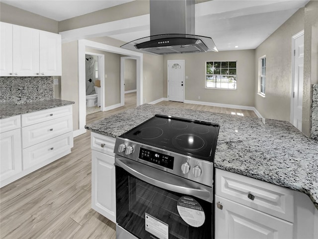 kitchen with white cabinets, electric range, light stone counters, and range hood