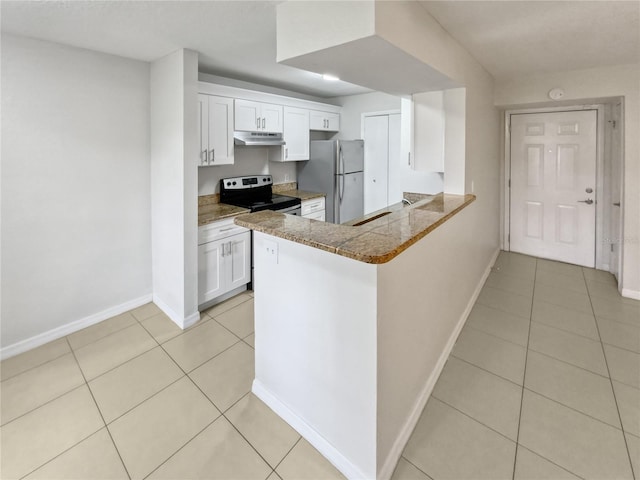 kitchen featuring white cabinets, dark stone countertops, kitchen peninsula, stainless steel appliances, and light tile patterned flooring