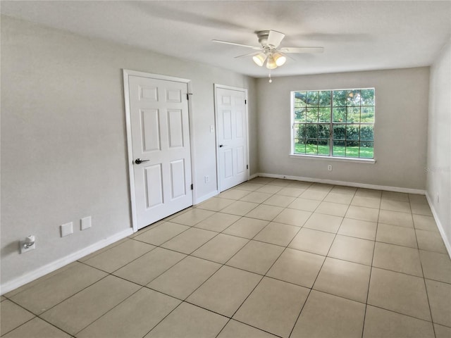 unfurnished bedroom featuring light tile patterned flooring and ceiling fan