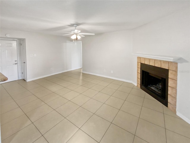 unfurnished living room featuring ceiling fan, light tile patterned floors, and a fireplace