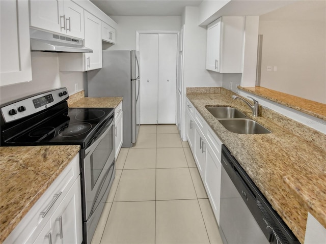 kitchen with light stone countertops, appliances with stainless steel finishes, light tile patterned floors, sink, and white cabinets