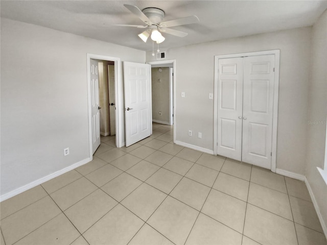 unfurnished bedroom featuring ceiling fan, light tile patterned floors, and a closet