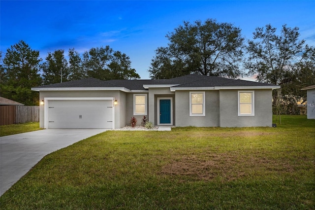 ranch-style house featuring a garage and a yard