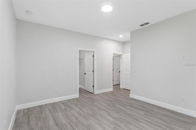 spare room featuring light hardwood / wood-style floors