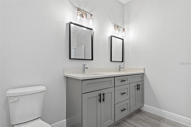 bathroom with double sink vanity and toilet