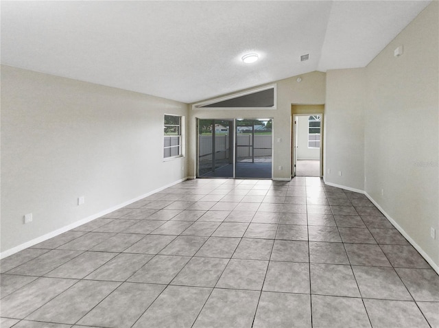 tiled empty room with vaulted ceiling